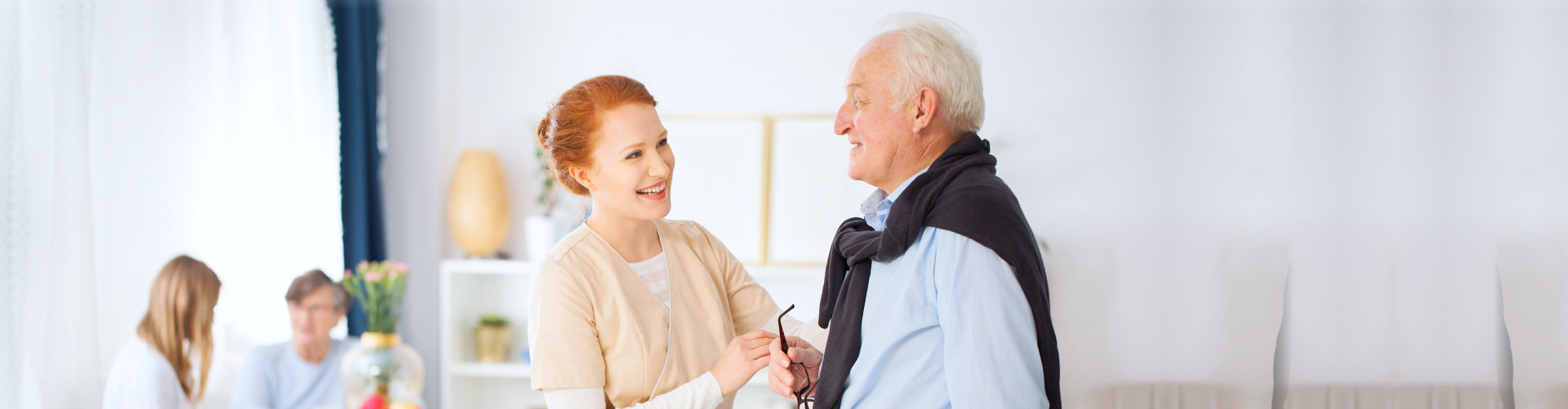caregiver helping senior man to walk